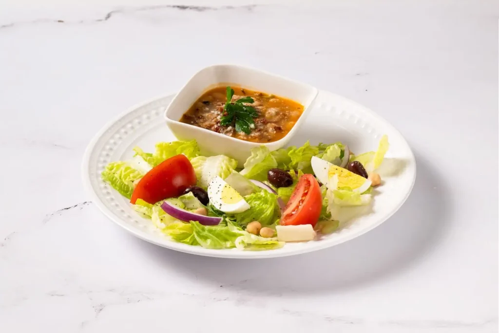 Fresh salad served with a bowl of soup at Anthony’s Coal Fired Pizza, a light Italian food option perfect for lunch specials.