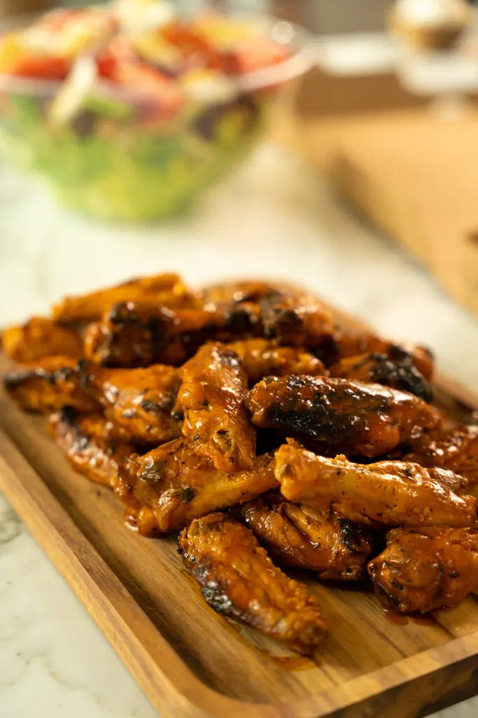 A platter of 50 coal oven chicken wings with garlic knots and a choice of salad in Anthony’s Just Wing It Package, a wing lover’s dream.