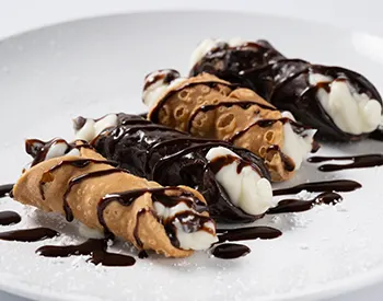 Mini cannolis filled with sweet ricotta cream and dusted with powdered sugar, a crisp and creamy Italian dessert favorite.