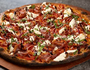 Coal fired pizza topped with pepperoni, creamy burrata, and a drizzle of hot honey, balancing smoky heat with rich cheese.