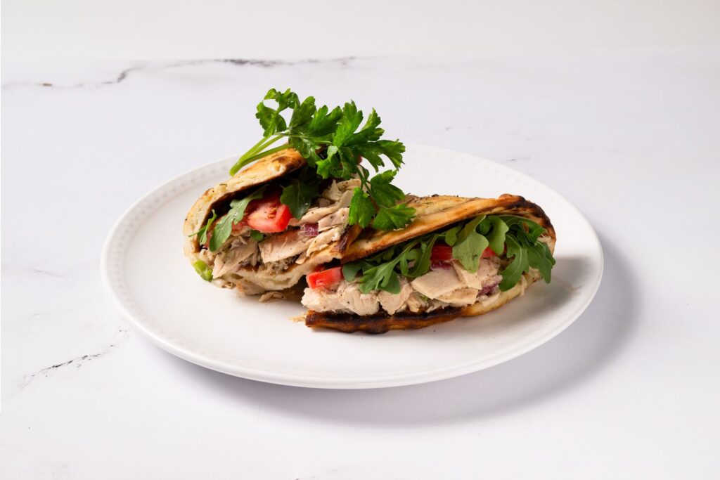 Zesty Italian tuna salad with greens and tomato served on crispy bread at Anthony’s, great for a lighter lunch option.