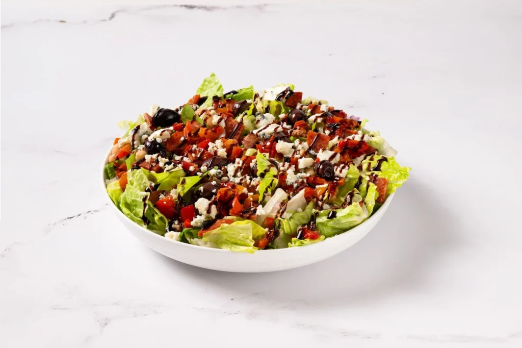 Anthony’s Italian chopped salad with olives, chickpeas, and tomatoes, fresh and flavorful before your pizza or pasta order.